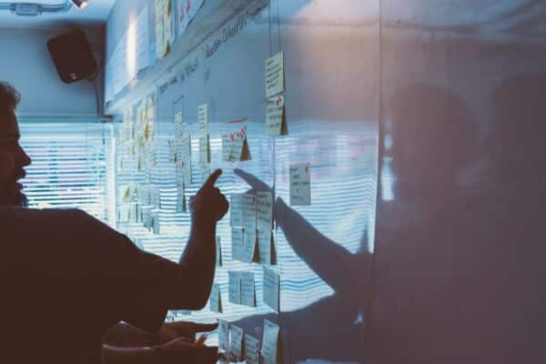 Team brainstorming with sticky notes on a whiteboard, focusing on influencer marketing strategies.